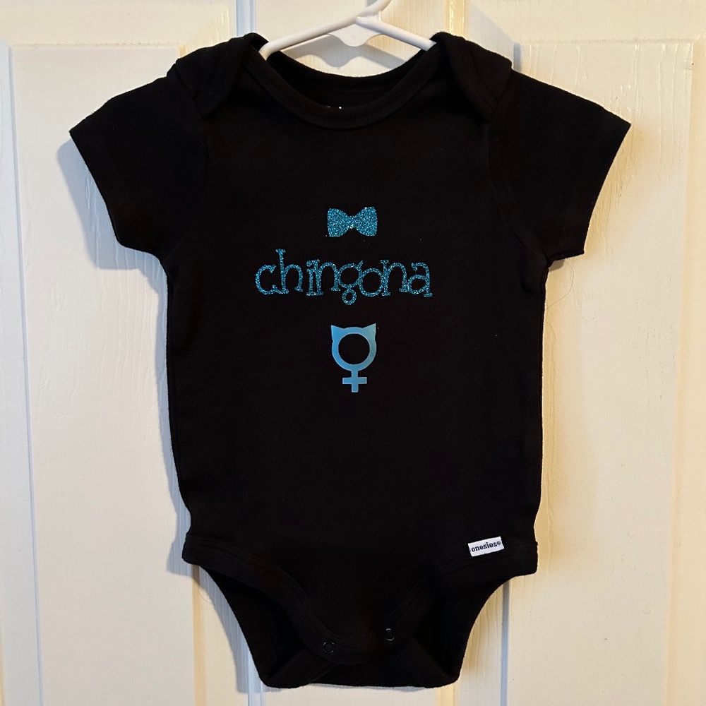 Gerber Baby Black Onsie Size 6-9months with “chingona” on front.